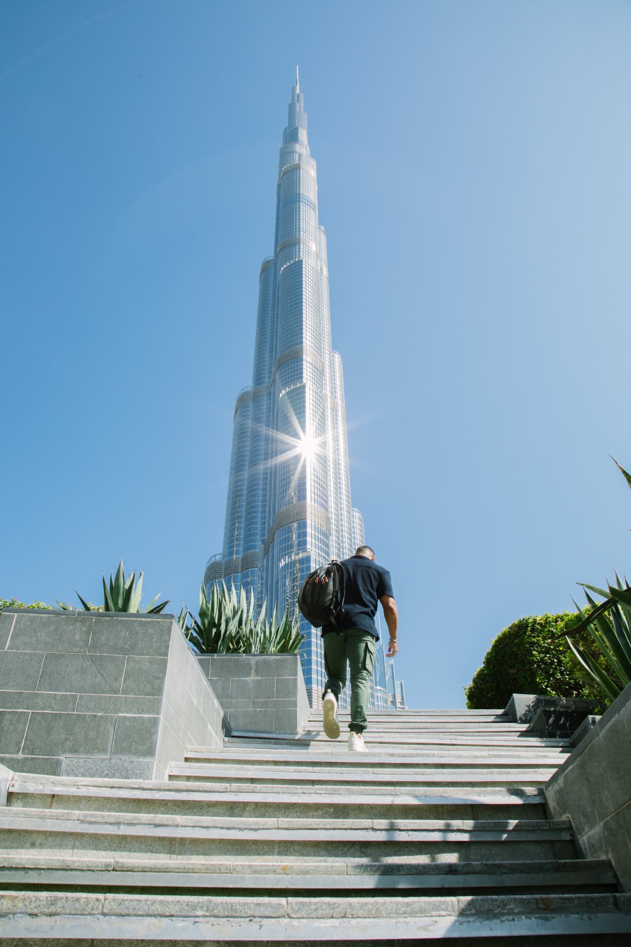 Tobias Paraiso caminhando em ambiente urbano com vista para o Burj Khalifa